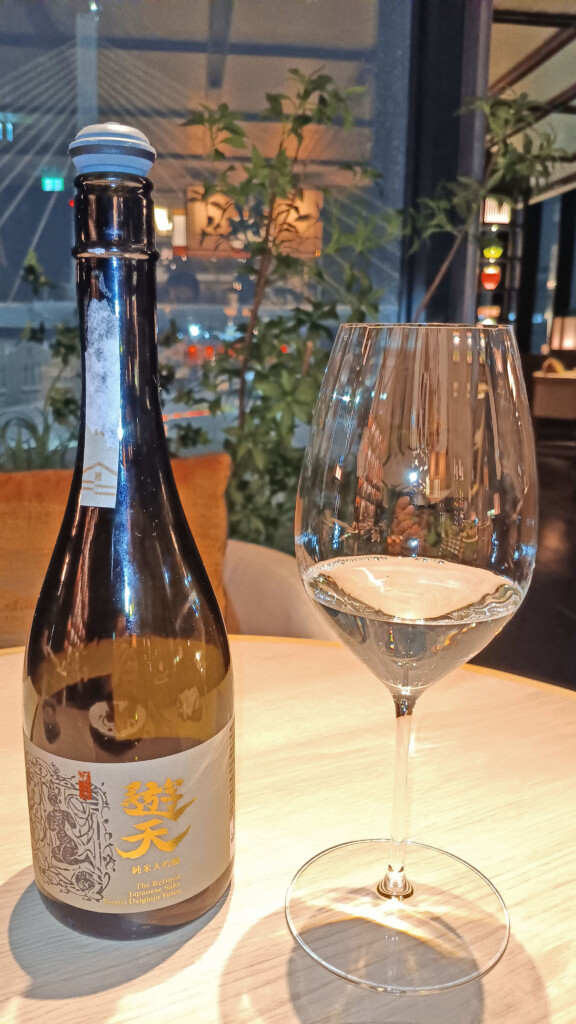 a bottle and glass of wine on a table