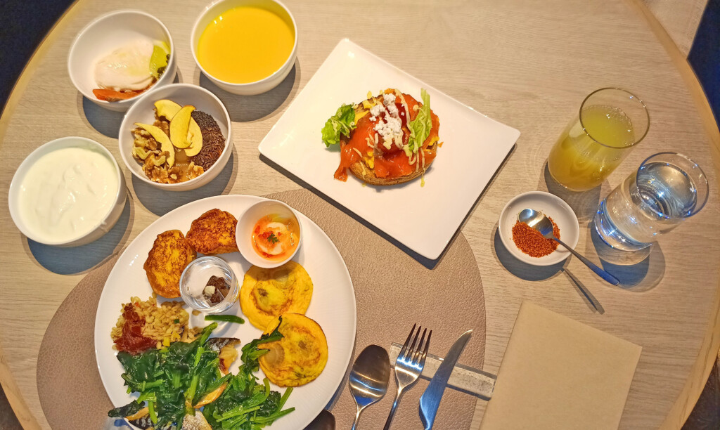 a table with plates of food and drinks