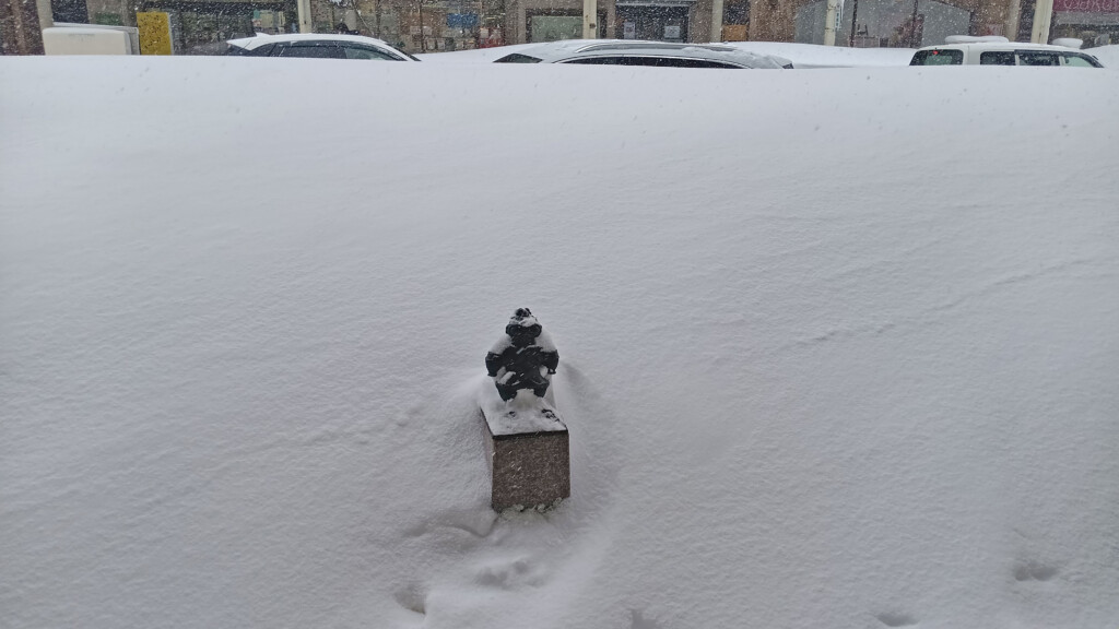 a statue on a snow covered ground
