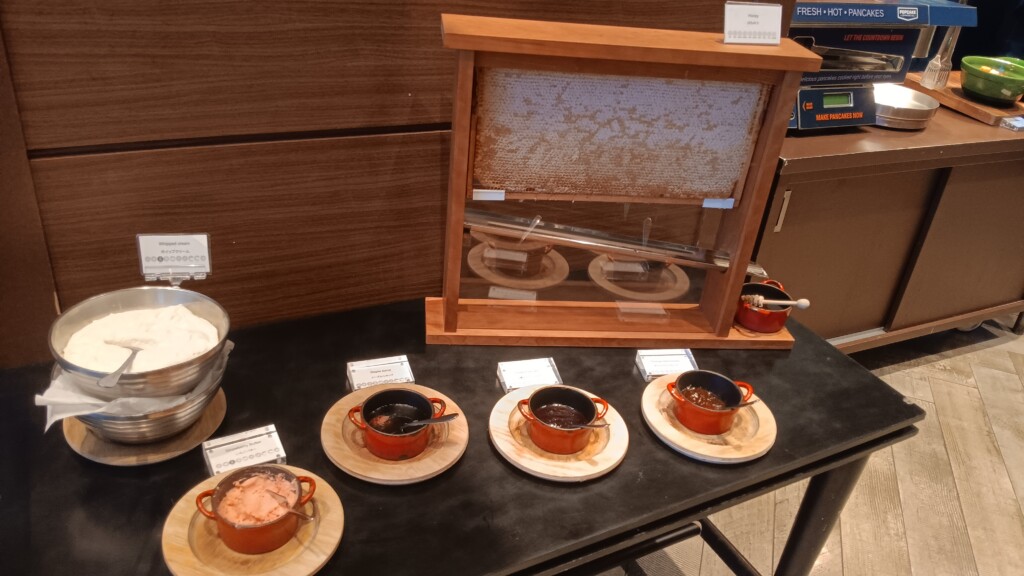 a table with plates and bowls of food on it