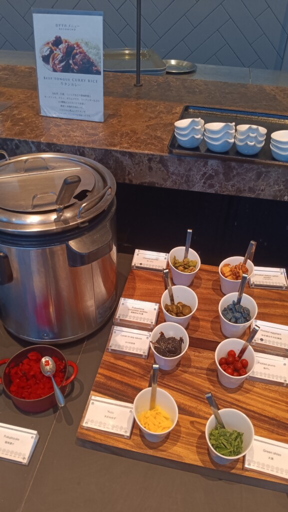 a table with bowls of food and a pot of food
