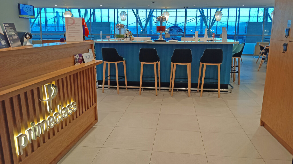 a bar with chairs in front of a window
