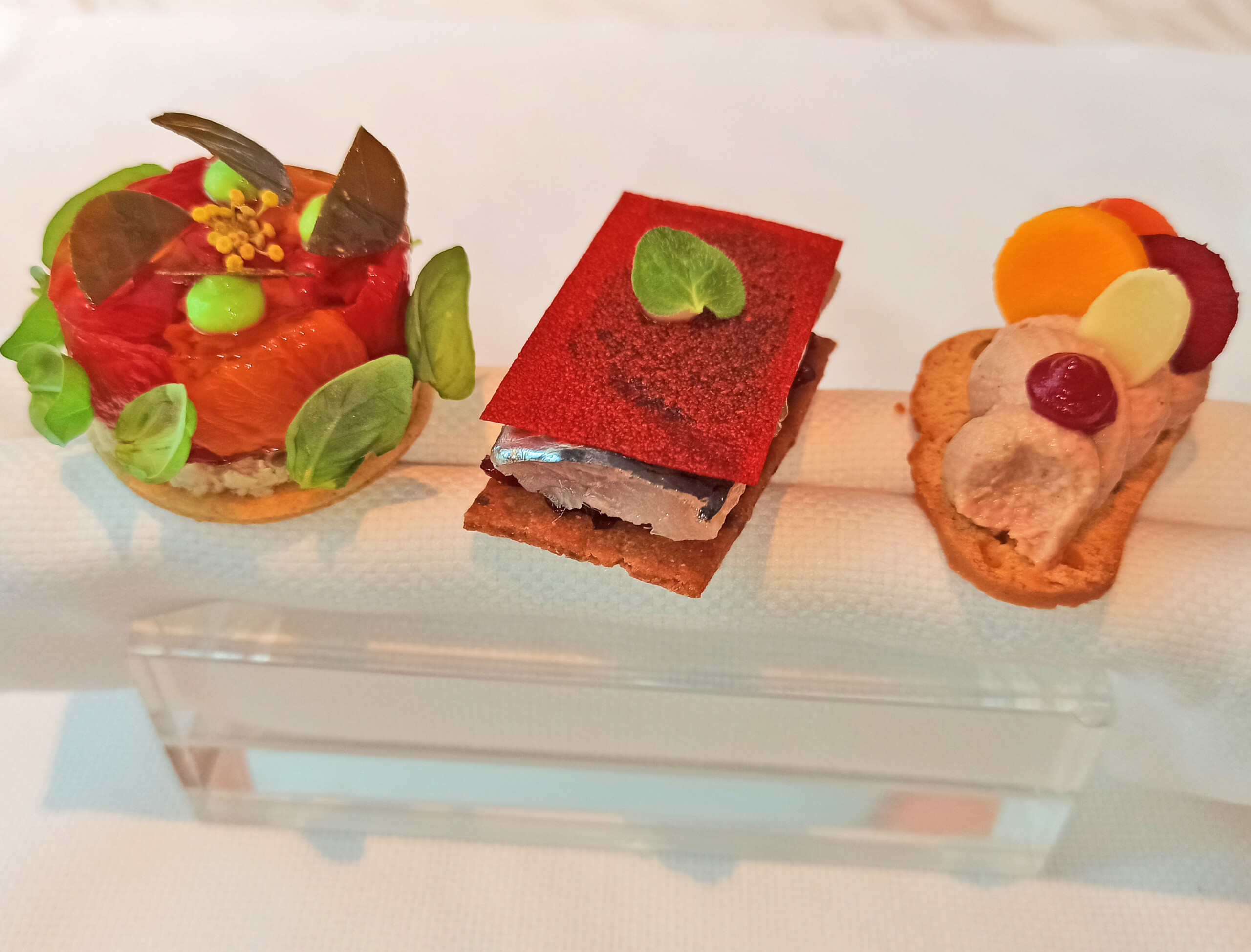 Amuse-bouche: Tartelletta Pomodoro e Capperi Tomato and eggplant tart, fennel, caper leaf Toast di Sardine Marinated sardines, Tropea onion, Senise pepper crisp Paté di Fegatelli e Ciliegie Duck foie gras and chicken liver parfait, cherry, Noto almond cookie